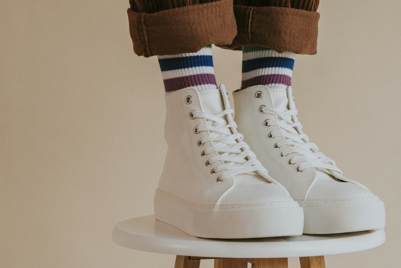 man in white high top shoes standing on chair.jpg